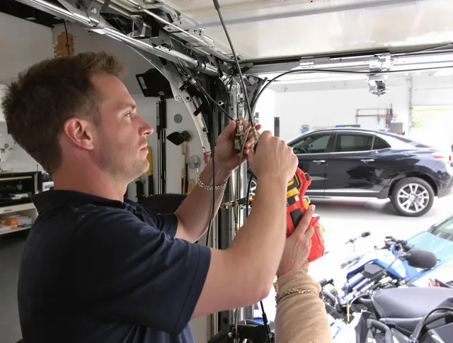 Garfield Heights Garage Door Repair safety certified technician performing cable replacement in Garfield Heights